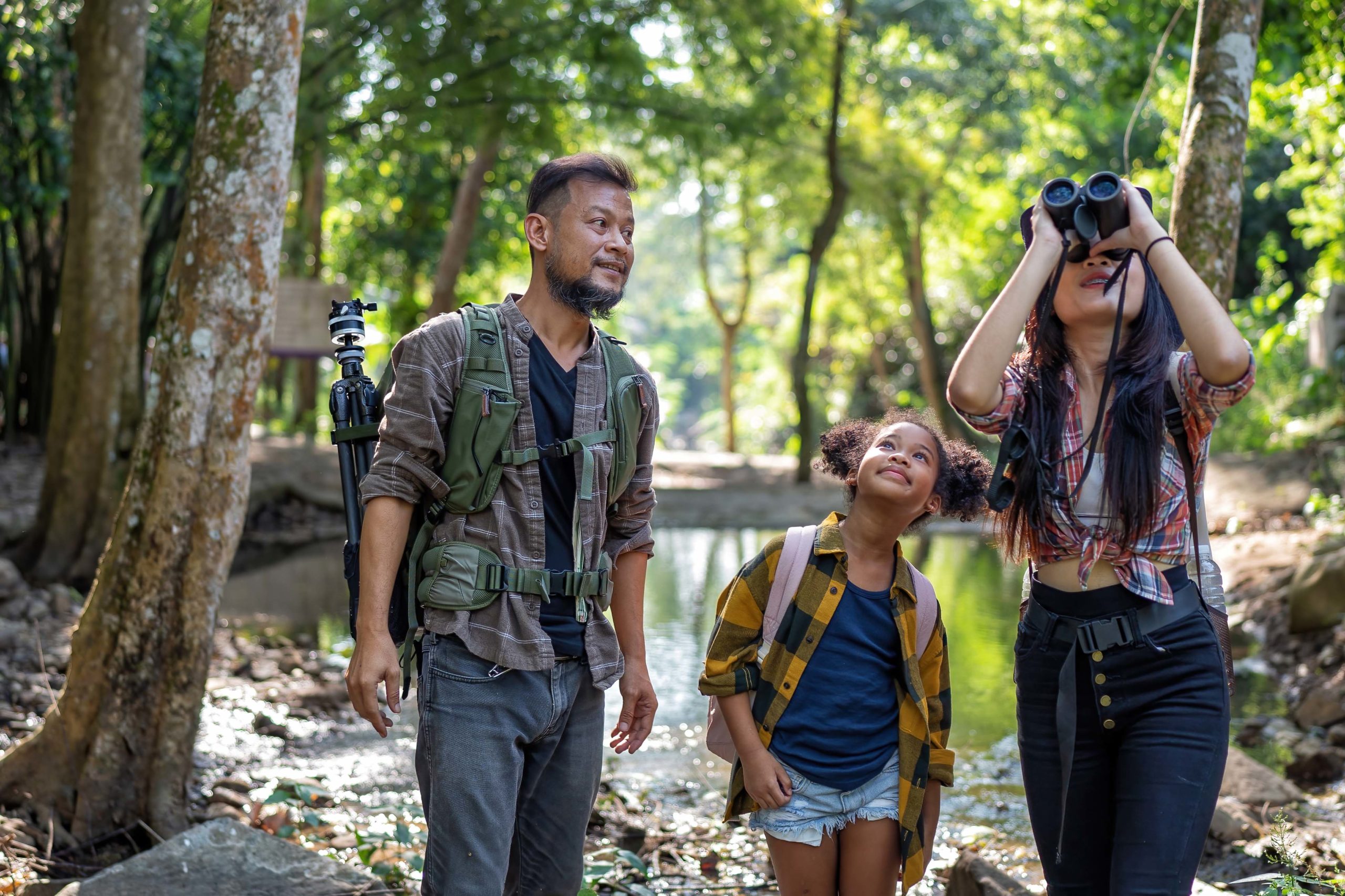 Backpack traveler family with little girl outdoor adventure bird